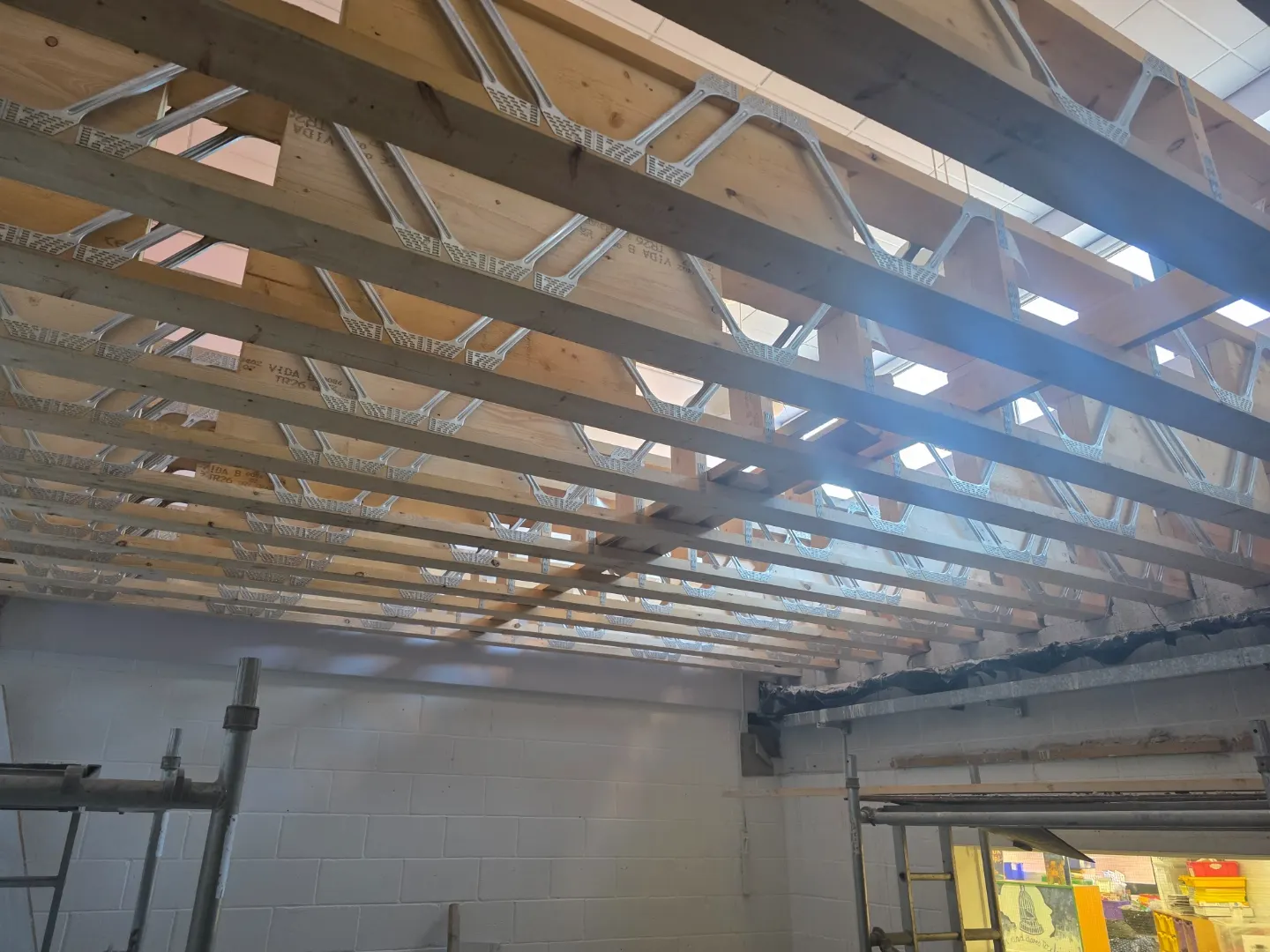 Timber roof structure exposed above a school nursery during alteration works.