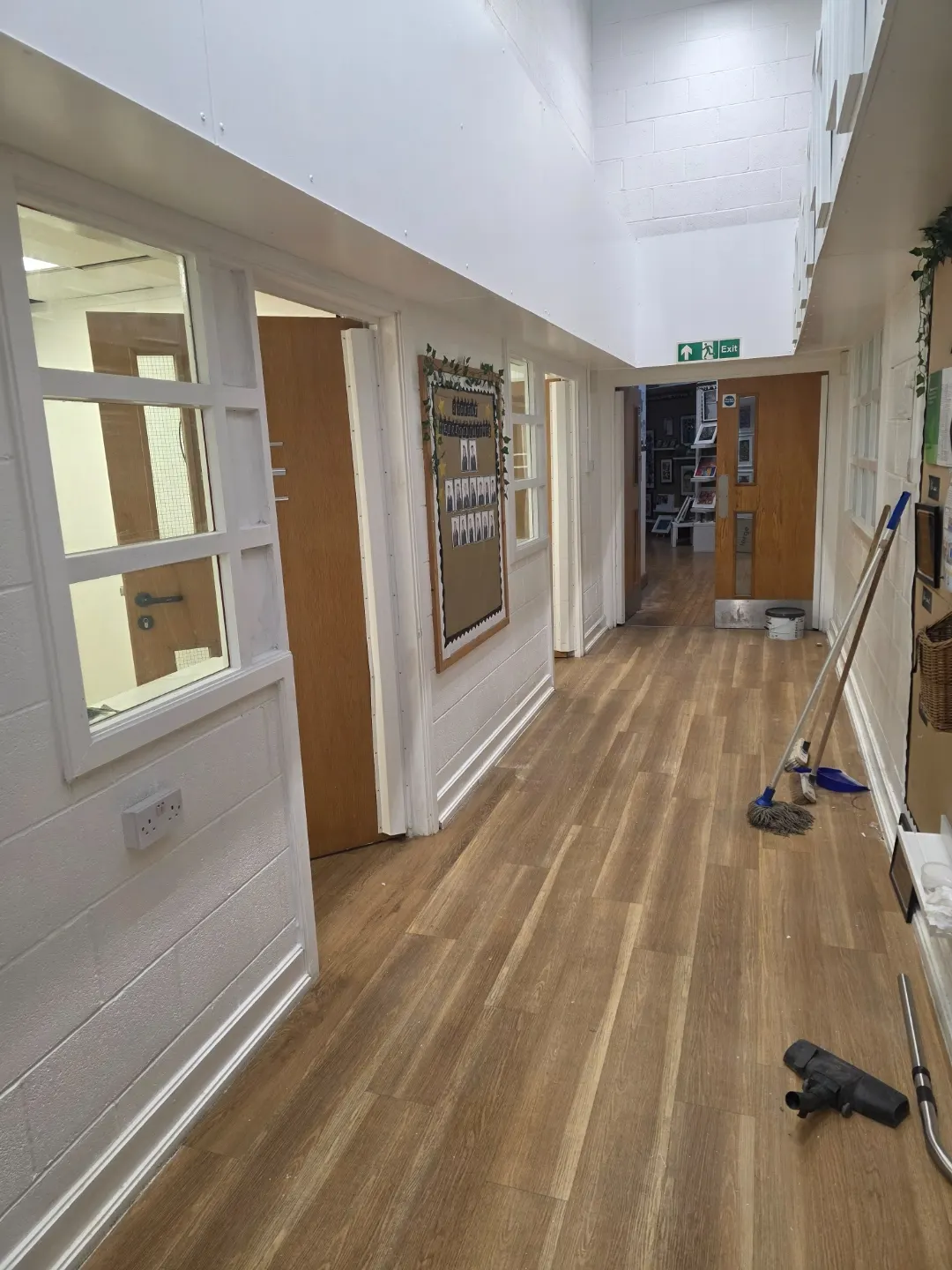 School corridor with new vision panels, doors and LVT flooring after the office alterations.