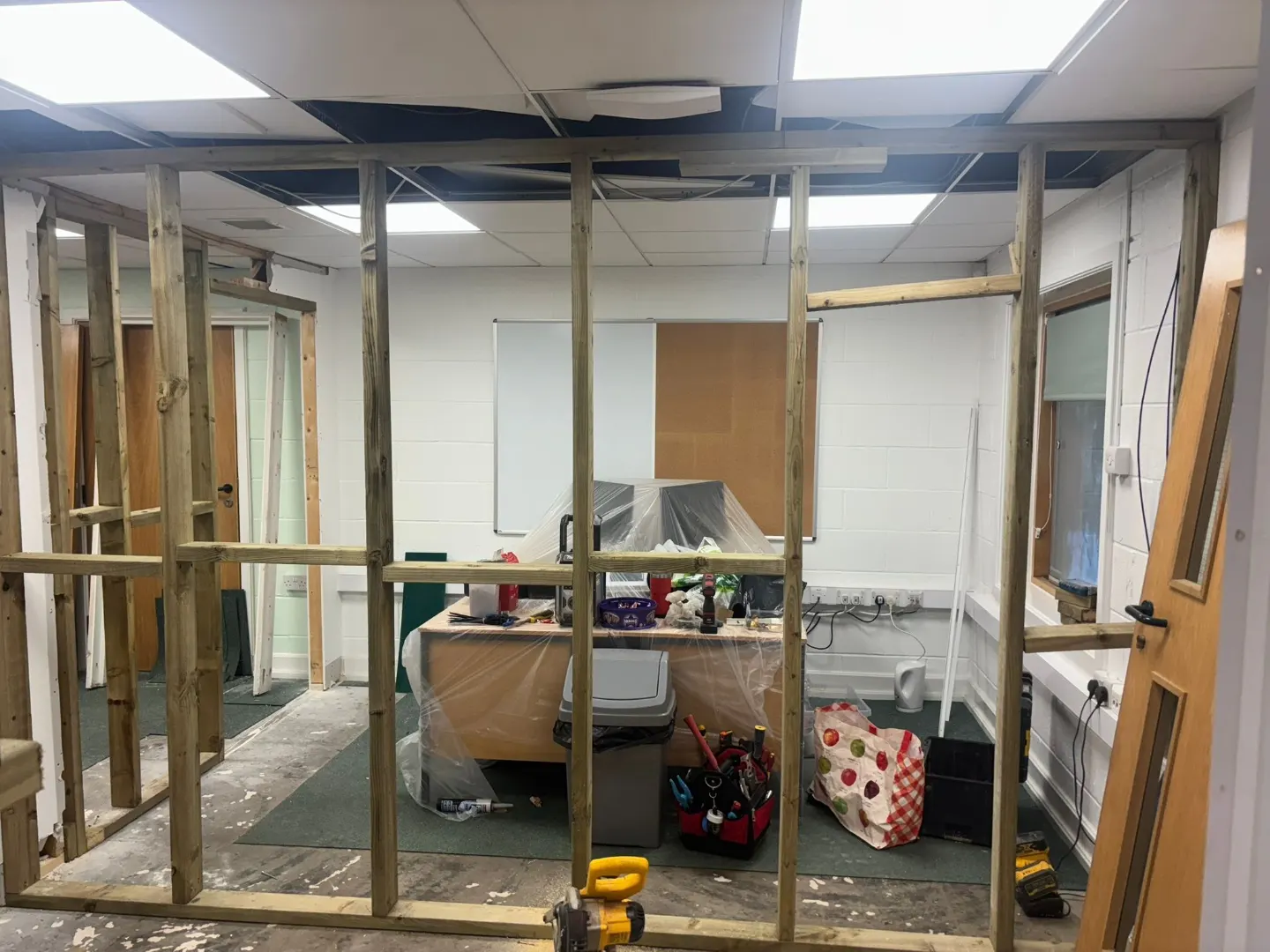 New timber stud partition frames erected within a school office prior to boarding.