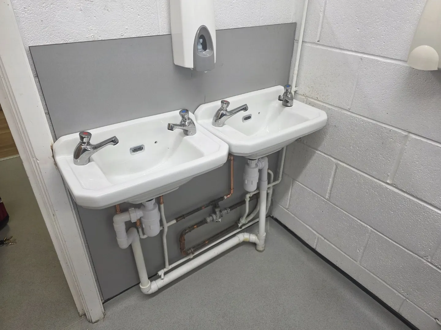 New washroom with a run of basins, splashbacks and vanity units.