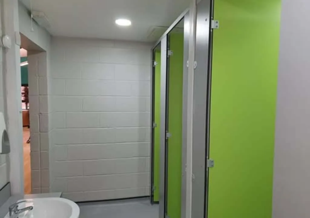 Refurbished school washroom block with new cubicles and wall panelling.
